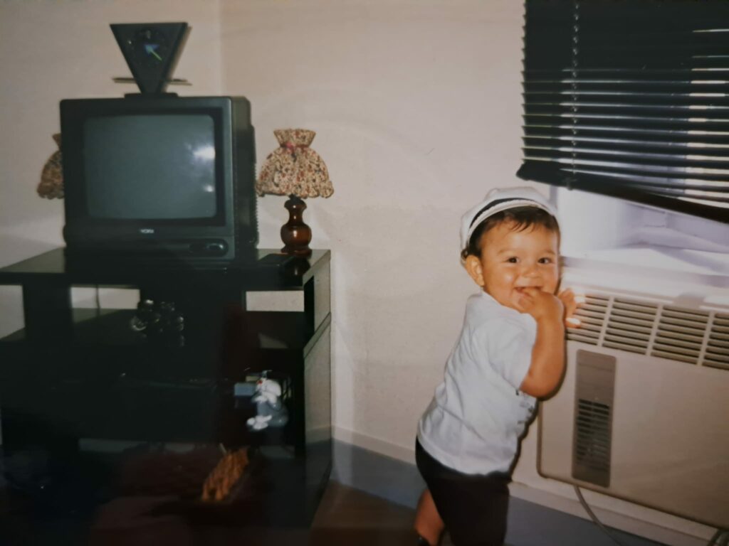 Photo ancienne et vintage d'un enfant qui sourit, dans un salon des années 90